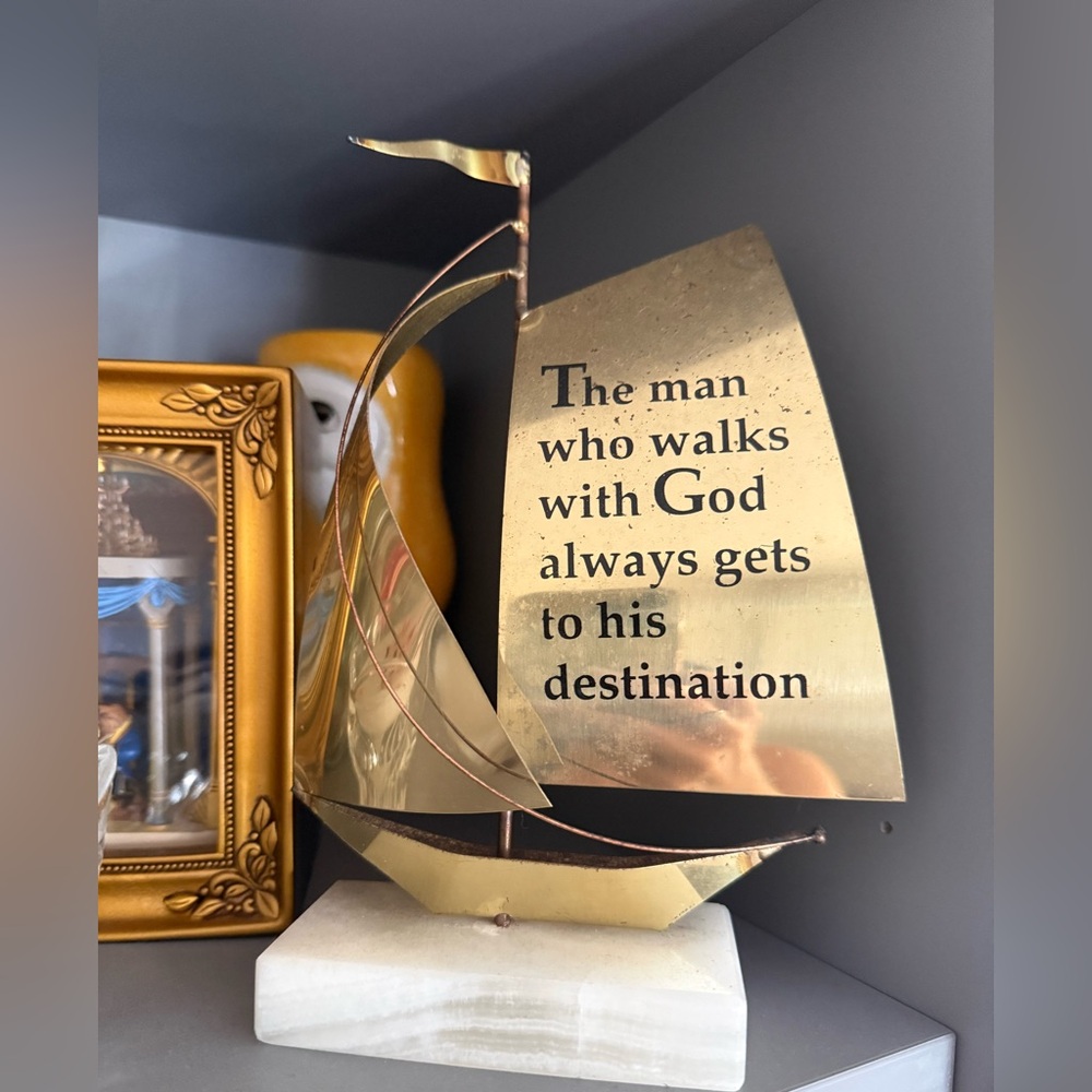 brass sailboat on marble base with Bible sculpture text engraved on its sail.